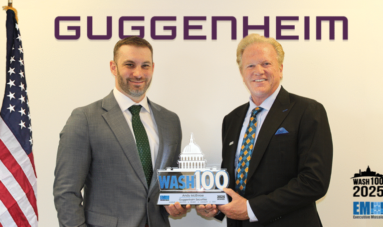Andy McEnroe of Guggenheim Securities posing with Jim Garrettson and the 2025 Wash100 Award