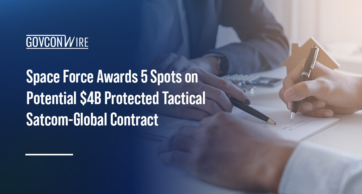 Two people signing a contract. The Space Force tapped five vendors for the PTS-G IDIQ contract.