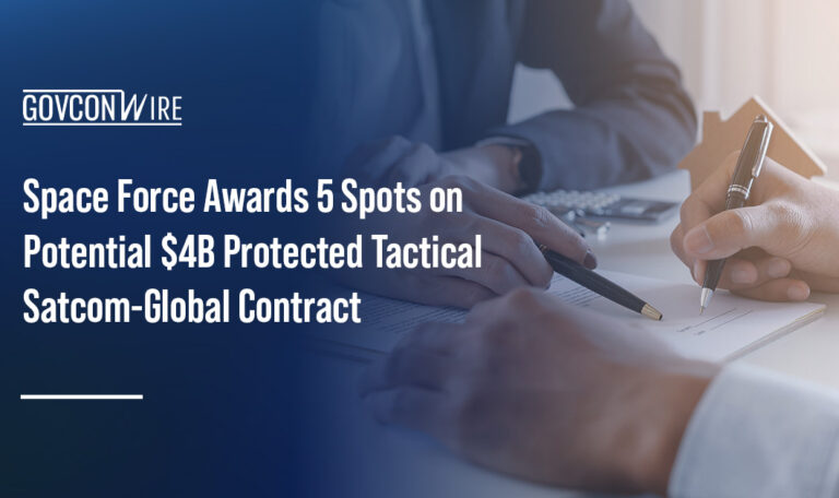 Two people signing a contract. The Space Force tapped five vendors for the PTS-G IDIQ contract.